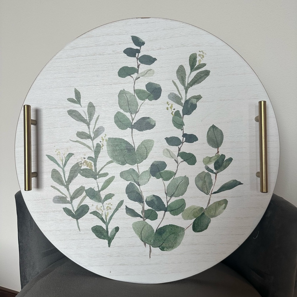 White wooden decorative serving tray with greenery leaves and gold handles
